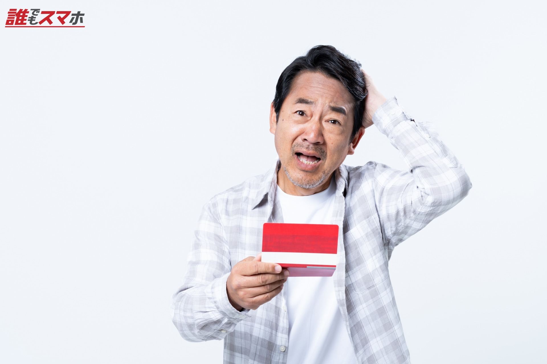 通帳で悩むミドルの男性