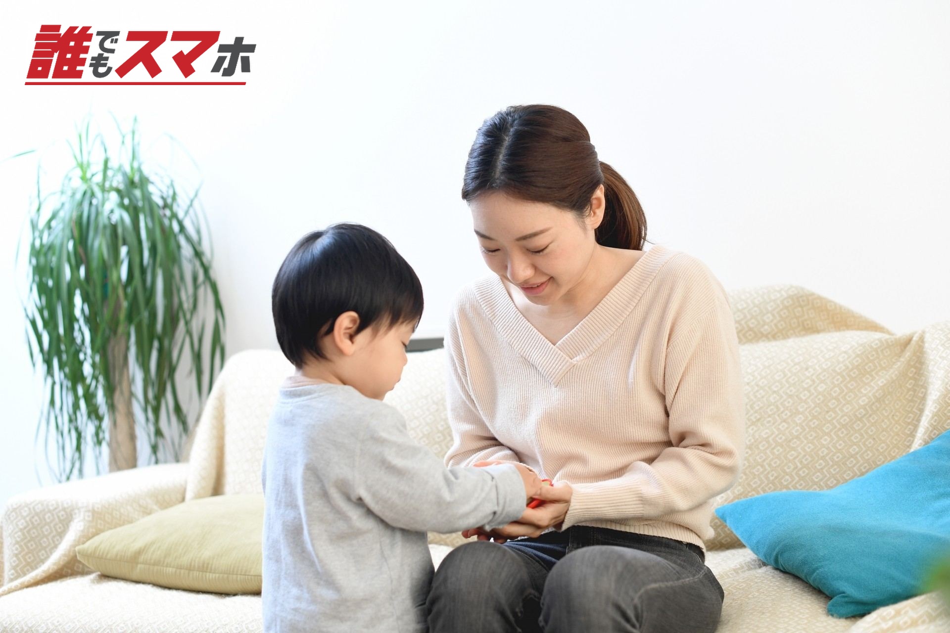 室内で子供(息子)と遊ぶ母親