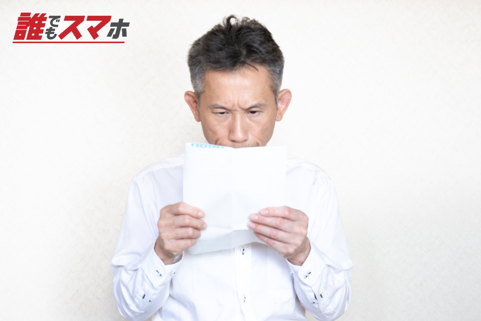 書類をのぞき込む中高年男性