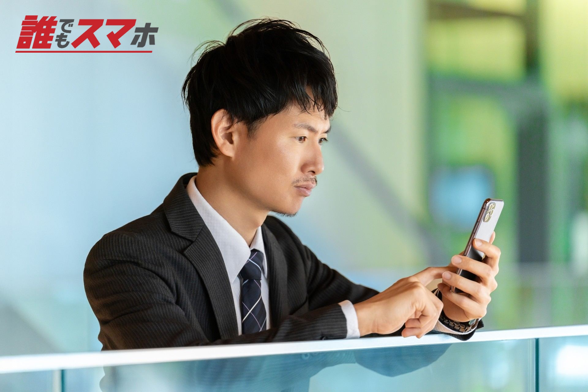 スマホの画面を見て考える男性ビジネスマン