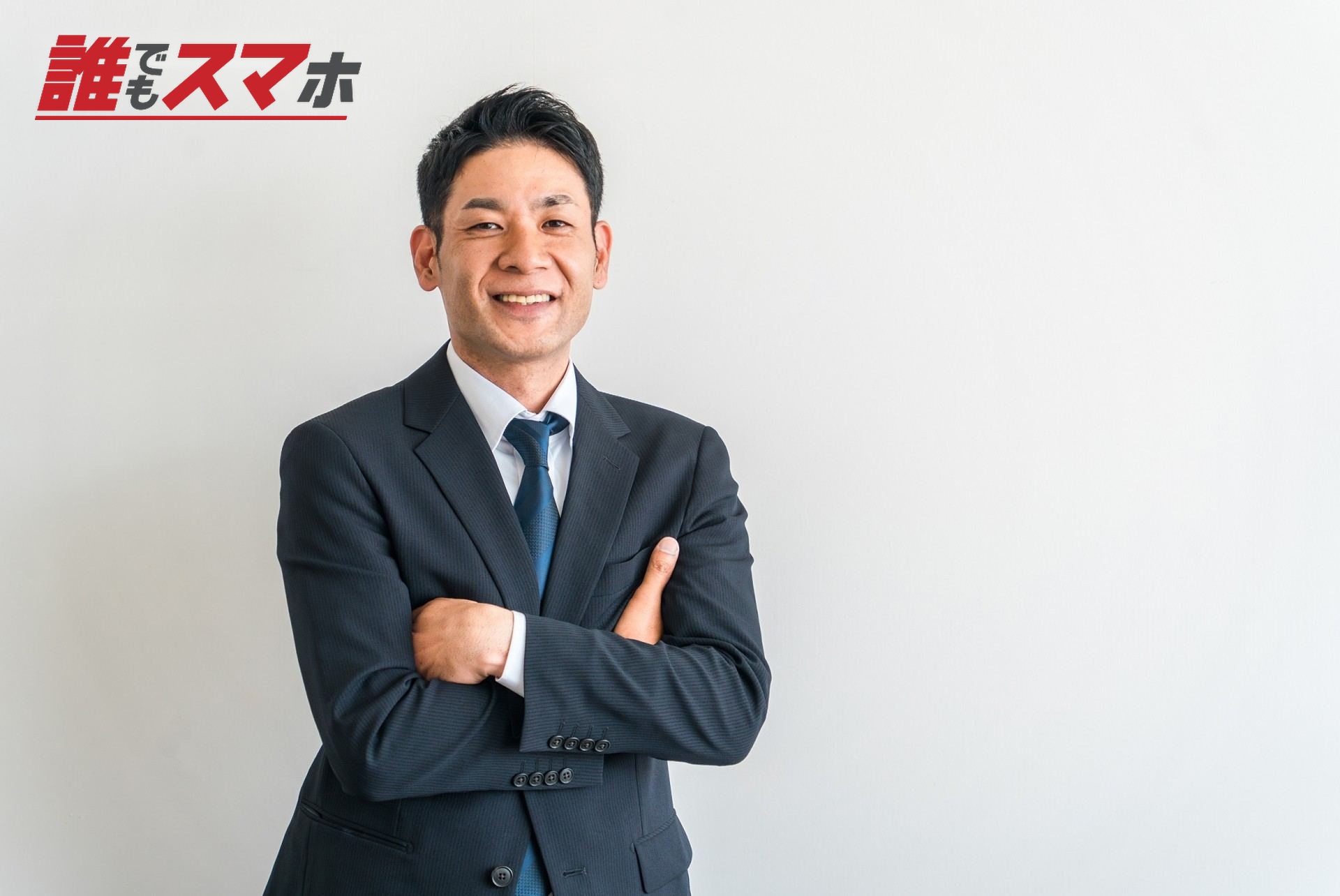 腕組みするスーツ姿のアジア人ビジネスマン