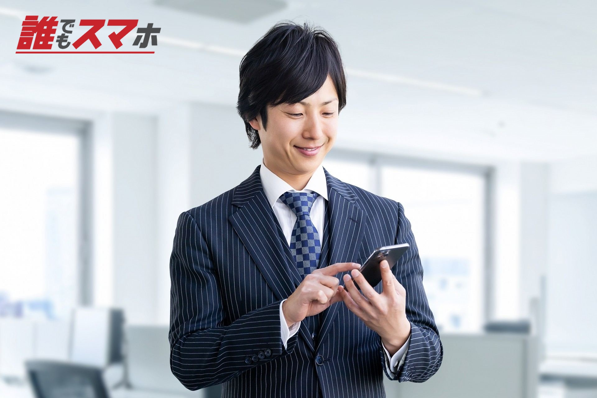 スマホを見るスーツの男性