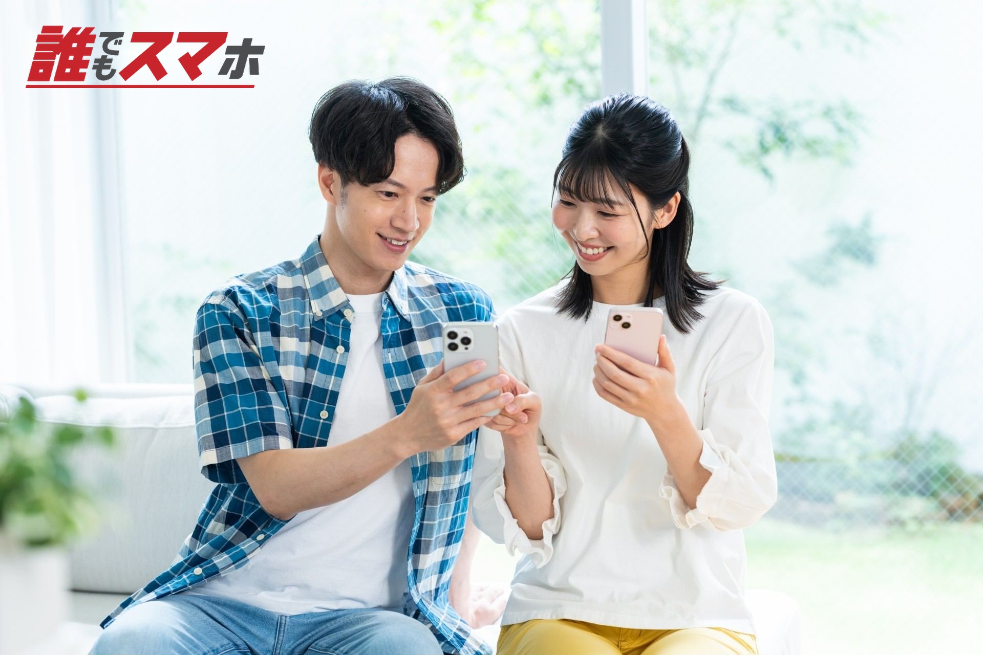 リビングでスマホを見るカップル