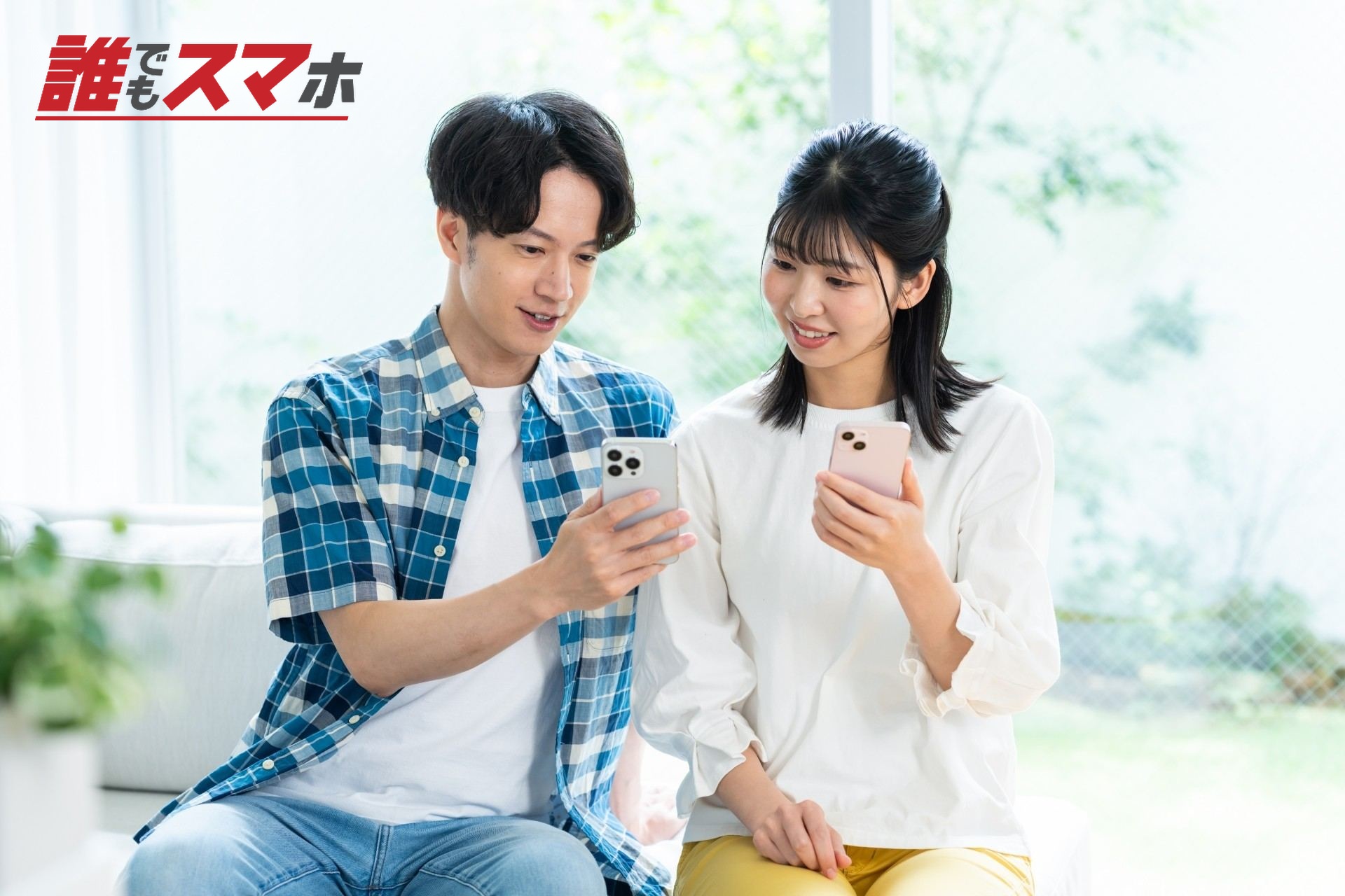 リビングでスマホを見るカップル