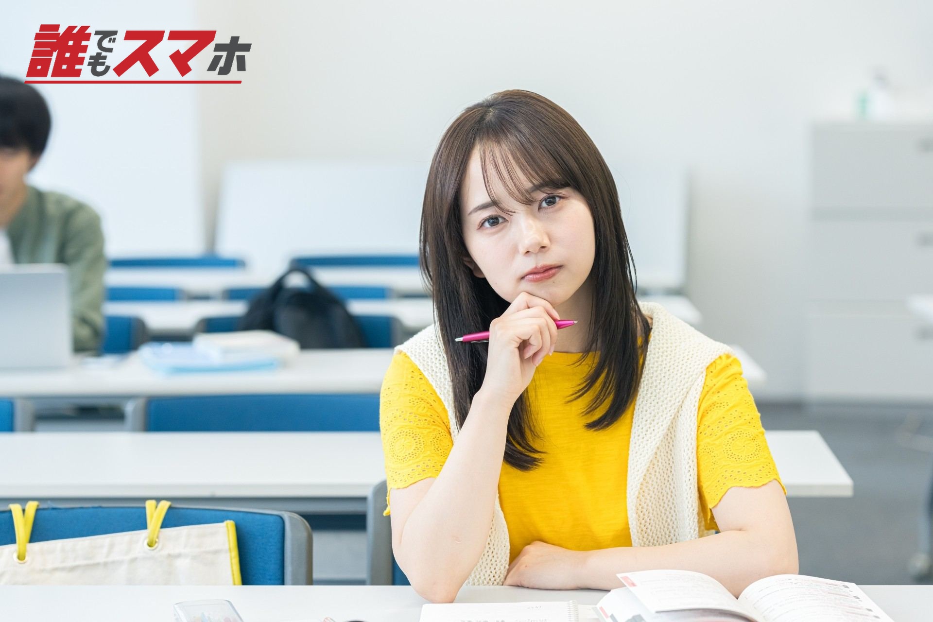 ペンを持ちながら悩む女性