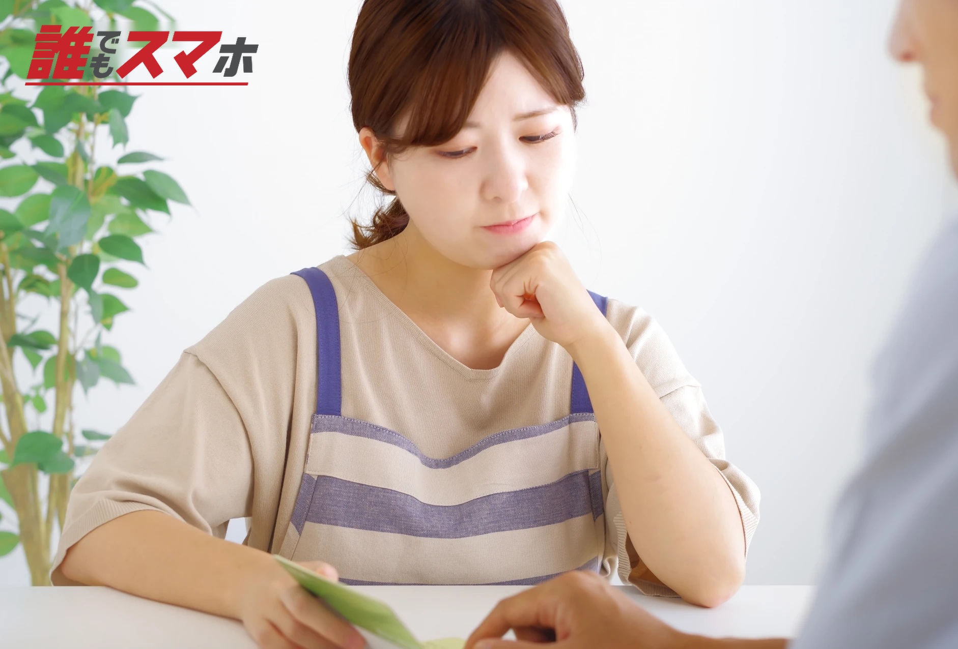 悩むエプロンをした女性
