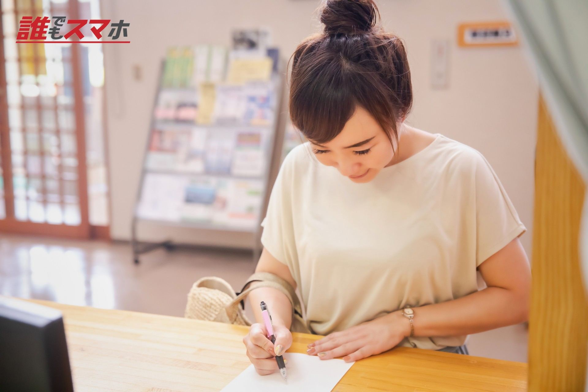 受付で何か書き込む女性
